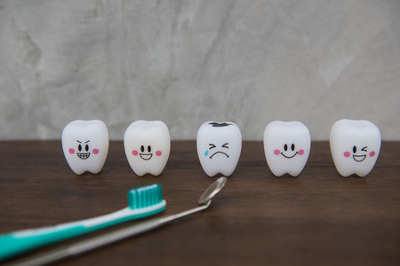 Model Cute toys teeth in dentistry on a wooden table and wall gray background.の写真素材