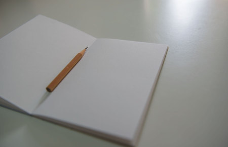 Pencils on the white book on the table .の写真素材