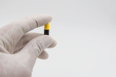 Colorful  capsules drug  in hand on white background.の写真素材