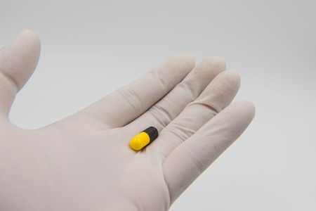 Colorful  capsules drug  in hand on white background.