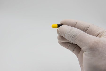 Colorful  capsules drug  in hand on white background.の写真素材