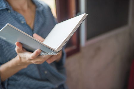 Women hold books in hand In the library .の写真素材