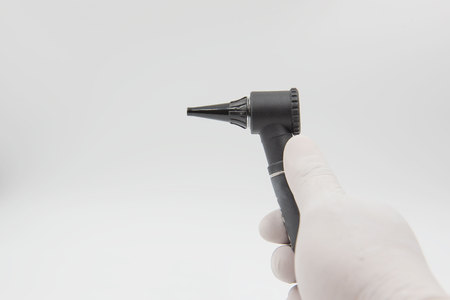 Otoscope  in hand doctor on the white background . medical equipment .の写真素材