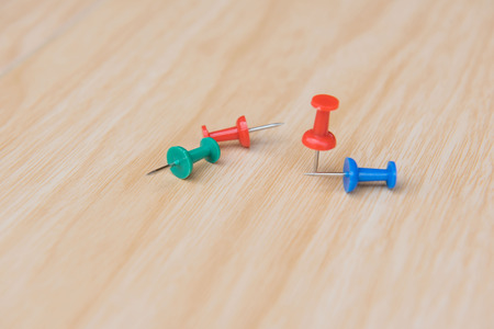 colorful  push pin marking on wooden floor for background.