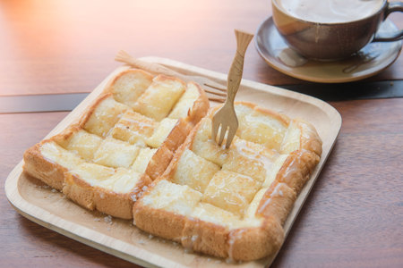 Bread and coffee set food and drink on wooden table in coffee shop at morning  .