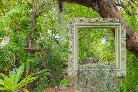 classic frame hanging on the tree in the garden .の写真素材