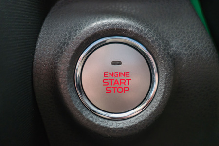 Close up start/stop engine button on a car .