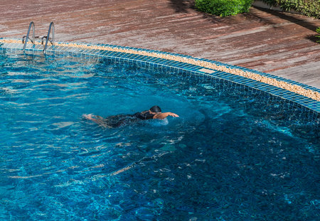 Young Man swimming in a pool .