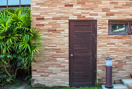 Old wooden door and Brown brick wall .の写真素材