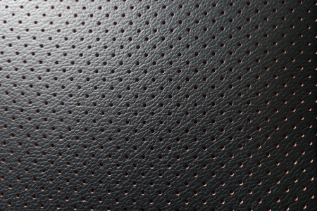 closeup perforated artificial black leather background texture .の写真素材