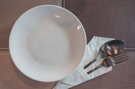top view set dishware , spoon and fork are placed on the table.の写真素材