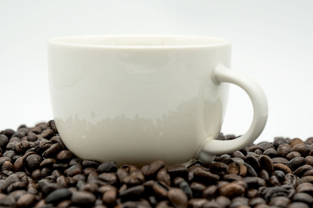 white coffee cup and coffee beans  isolated on white background .