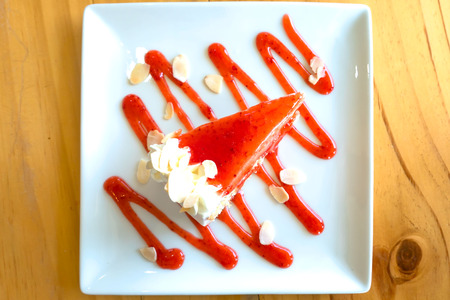 Strawberry cheesecake On a white plate on table  .