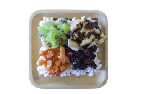 Mix fresh fruit salad in wooden plate Kiwi ,Strawberry, banana , Mulberry isolated on white backgroundの写真素材