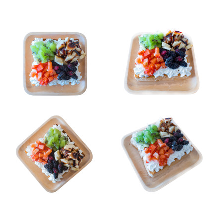 Mix fresh fruit salad in wooden plate  Kiwi ,Strawberry, banana , Mulberry isolated on white background . The collection of Mix fresh fruit salad .の写真素材