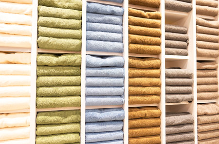 many colorful towels is folding in shelfs at store for Sales .の写真素材