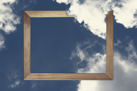 Square wooden frame, Creative Beautiful blue sky with white clouds for background . with paper card note. Blank for advertising card or invitation. Nature concept.の写真素材