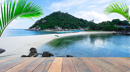 empty wood desk and summer blue sea background and leaf coconut palm tree .Blank space for text and images.Concept Summer, Beach, Sea, Relax, Party.の写真素材