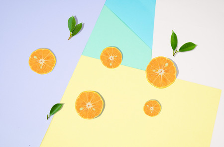 Top view Orange  fruit slice and green leaf   isolated on pastel color background .の写真素材