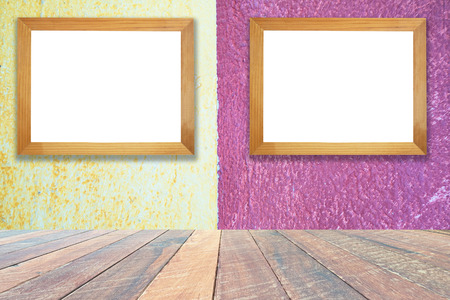 yellow and pink paint cement wall , vintage wallÂ TexturedÂ background .and empty wood desk and Wooden frame  .Blank space for text and images.の写真素材