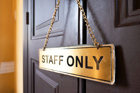 signs staff only  hang on the wooden door  .の写真素材