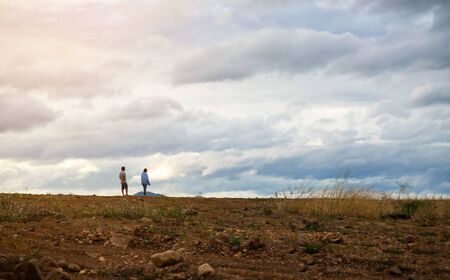 landscape at evening time man and woman standing sky background .