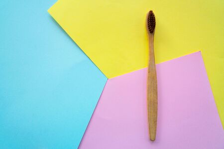 top view wooden ToothbrushÂ on colorful paper for background .