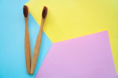 top view wooden ToothbrushÂ on colorful paper for background .の写真素材