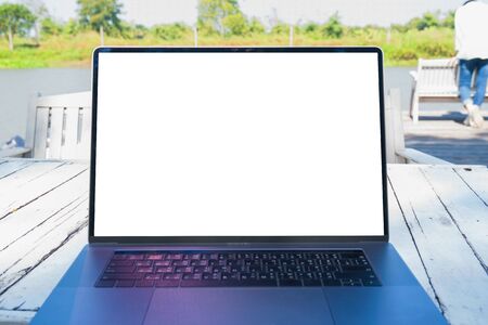 Laptop with blank white screen outdoor on table. computer Notebook .の写真素材