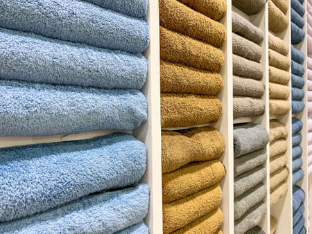 many colorful towels is folding in shelfs at store for Sales .の写真素材