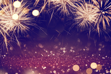 Gold and dark Fireworks and bokeh in New Year eve and copy space. Abstract background holiday.の写真素材