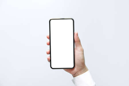 Smartphone mockup. Close up hand holding black phone white screen. Isolated on white background....