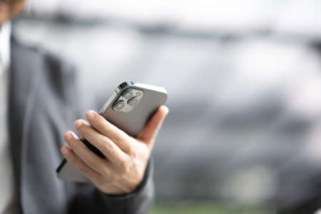 Bangkok, Thailand - Jan 13, 2021: Close up businesswoman hand holding black smartphone iPhone 12 Pro Maxのeditorial素材