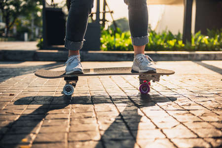 Close-up leg on surf skate or skateboard on the road, Sport activity lifestyle concept, Healthy and...