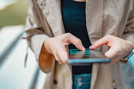 Closeup female using smartphone, she chatting online messaging and social network on mobile.