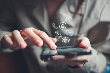 CONTACT US, Hand of woman holding mobile smartphone with ( mail,phone,email ) icon. customer support concept.の写真素材
