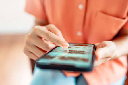 Woman browsing online store with wide variety of products available.の写真素材