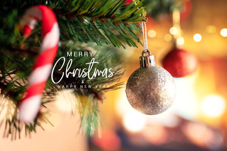 Merry Christmas and happy new year concept, Closeup of silver bauble hanging from a decorated Christmas tree with bokeh in home, Xmas holiday.の写真素材
