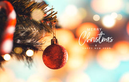 Merry Christmas and happy new year concept, Closeup of silver bauble hanging from a decorated Christmas tree with bokeh in home, Xmas holiday.の写真素材