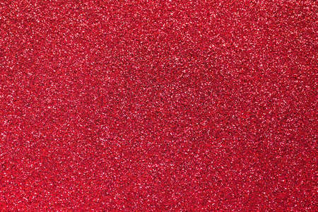 Red glitter background. Sparkle texture. Abstract twinkle background for Valentine or Christmas holiday.の写真素材