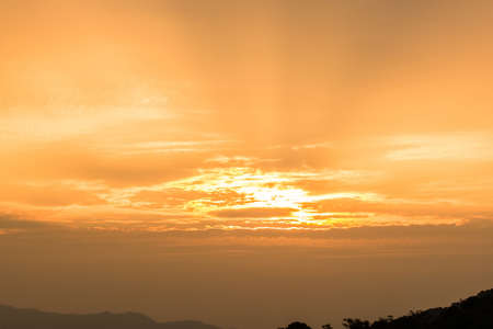 sun in orange cloudy skyの写真素材