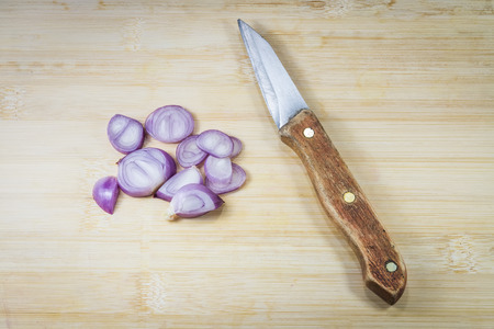 Shallots (red onion) set up on wood tableの写真素材