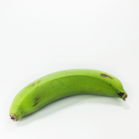 green bananas isolated on white backgroundの写真素材