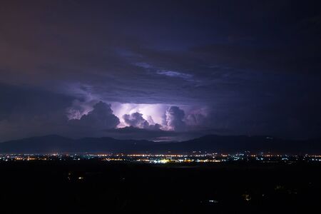 Lightning storm over city, Chiang mai, Thailandの写真素材