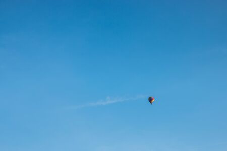 colorful hot air balloon in blue cloudy skyの写真素材