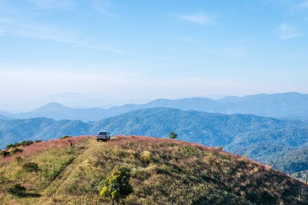 CHIANGMAI,Thailand-JAN 10,2016:Cars parked on a hill overlooking a beautiful mountain,Chiang mai,Thailandの写真素材