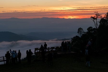 CHIANG MAI, THAILAND - DEC 04, 2016 Silhouette of many tourists watching sun rise with selfie smart pole on mountain at Mon Ngo,Chiang mai,Thailandのeditorial素材