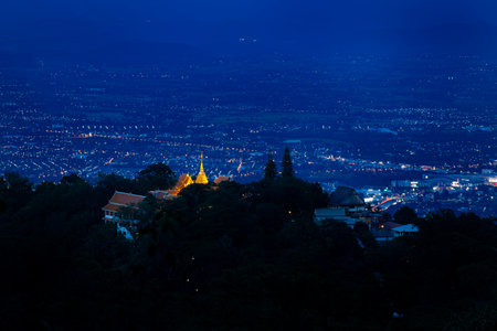 Wat Phra That Doi Suthep with night view of the city, architecture and twinkling lights at dusk.の写真素材