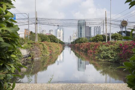FEB 13, 2016: The View Nature in capital of canal and a tree Building in the distance on Naradhiwas Rajanagarindra Road Bangkok., Thailandのeditorial素材