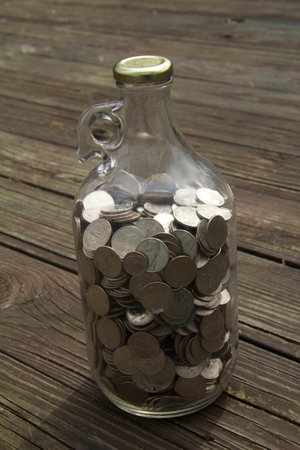 saving coins in bottleの写真素材